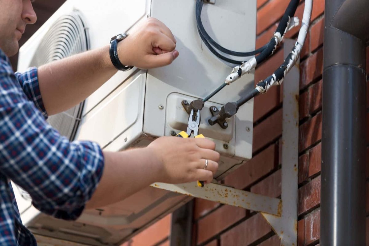 closeup-of-male-technician-repairing-outdoor-air-c-2021-12-09-17-34-31-utc-min-min.jpg